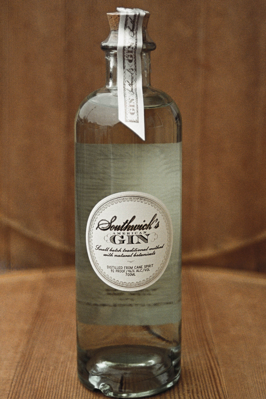 Stand alone bottle of Southwick's American Gin on a wood background - hand crafted in Connecticut.