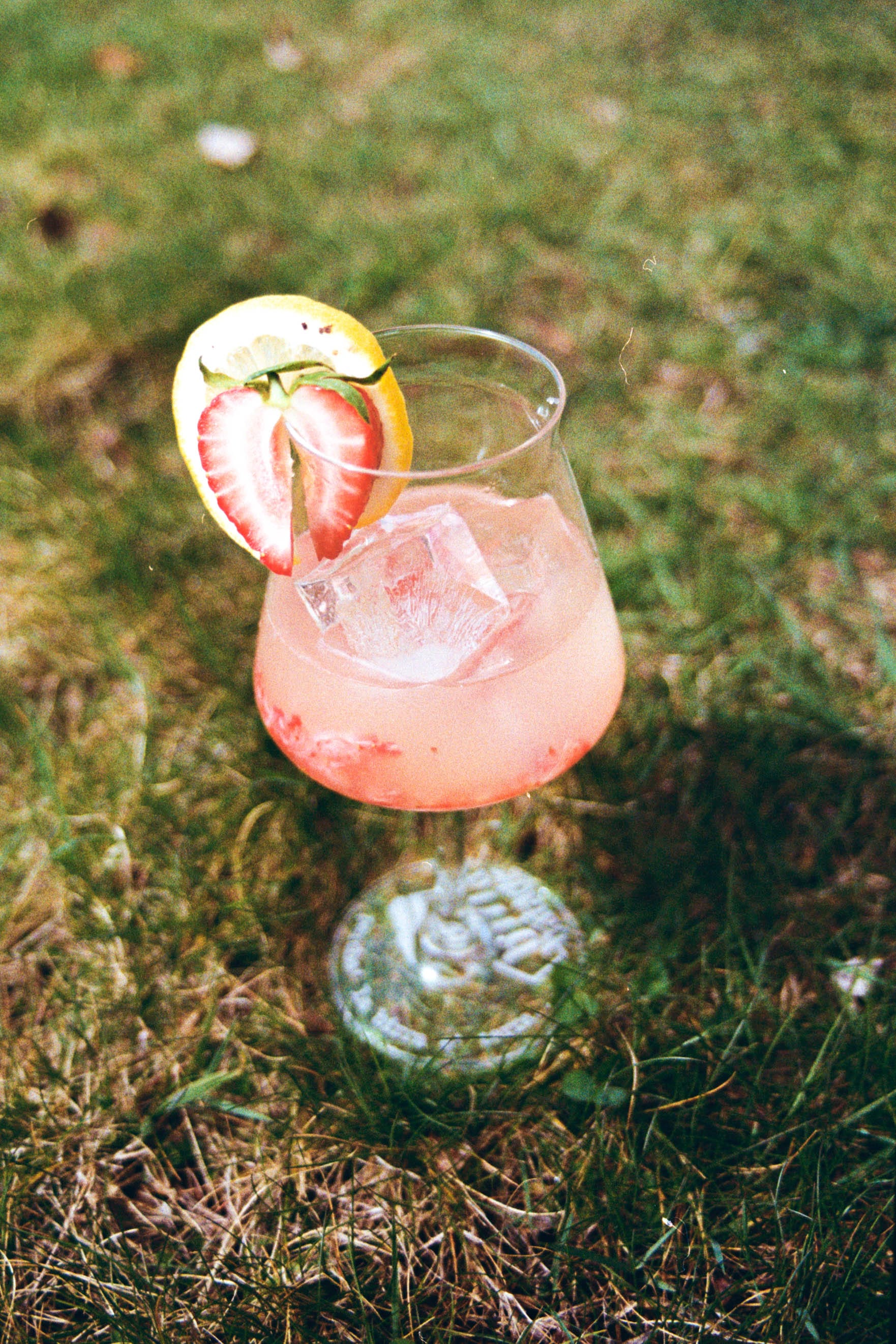 Image of the strawberry blond cocktail made using Veritable Limoncello, fresh strawberries and white wine and served in a whine glass garnished with a strawberry heart