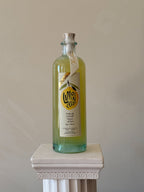 Bottle of 'Veritable Limoncello' on a white pedestal against a beige background